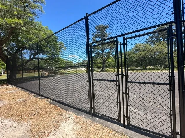 black chain link fence installed by top rail fence