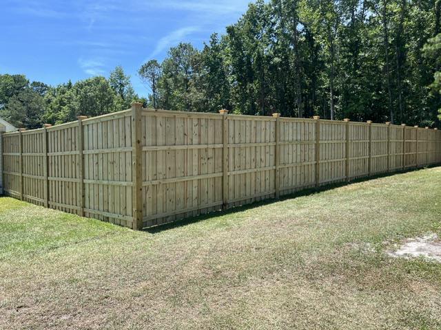 wood board on board cap and trim fence installed by top rail fence