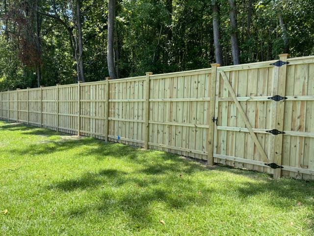 wood board on board cap and trim fence installed by top rail fence
