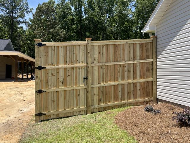 wood board on board cap and trim fence installed by top rail fence