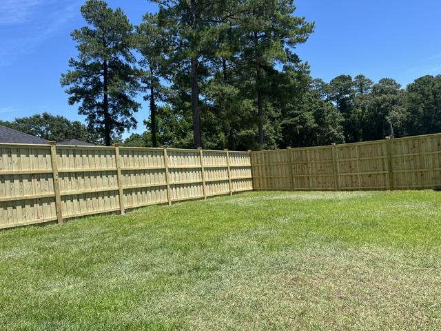 wood board on board cap and trim fence installed by top rail fence
