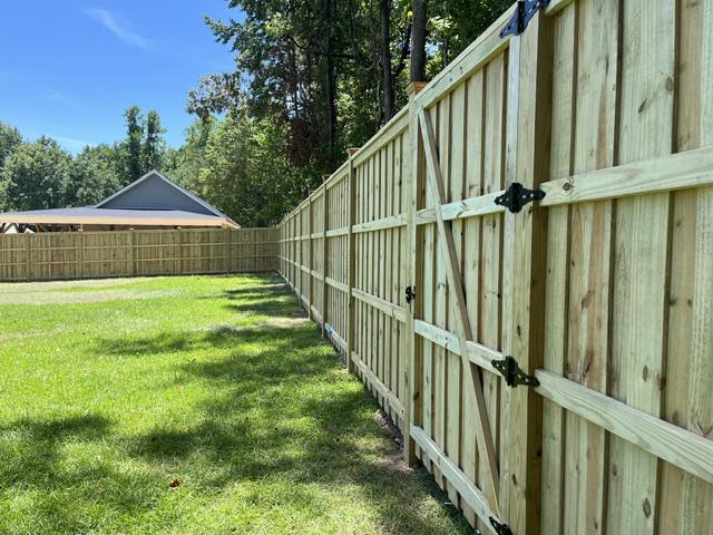 wood board on board cap and trim fence installed by top rail fence