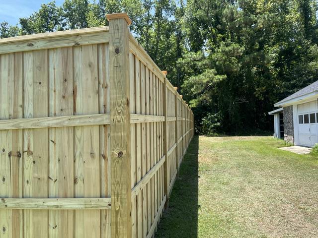 wood board on board cap and trim fence installed by top rail fence