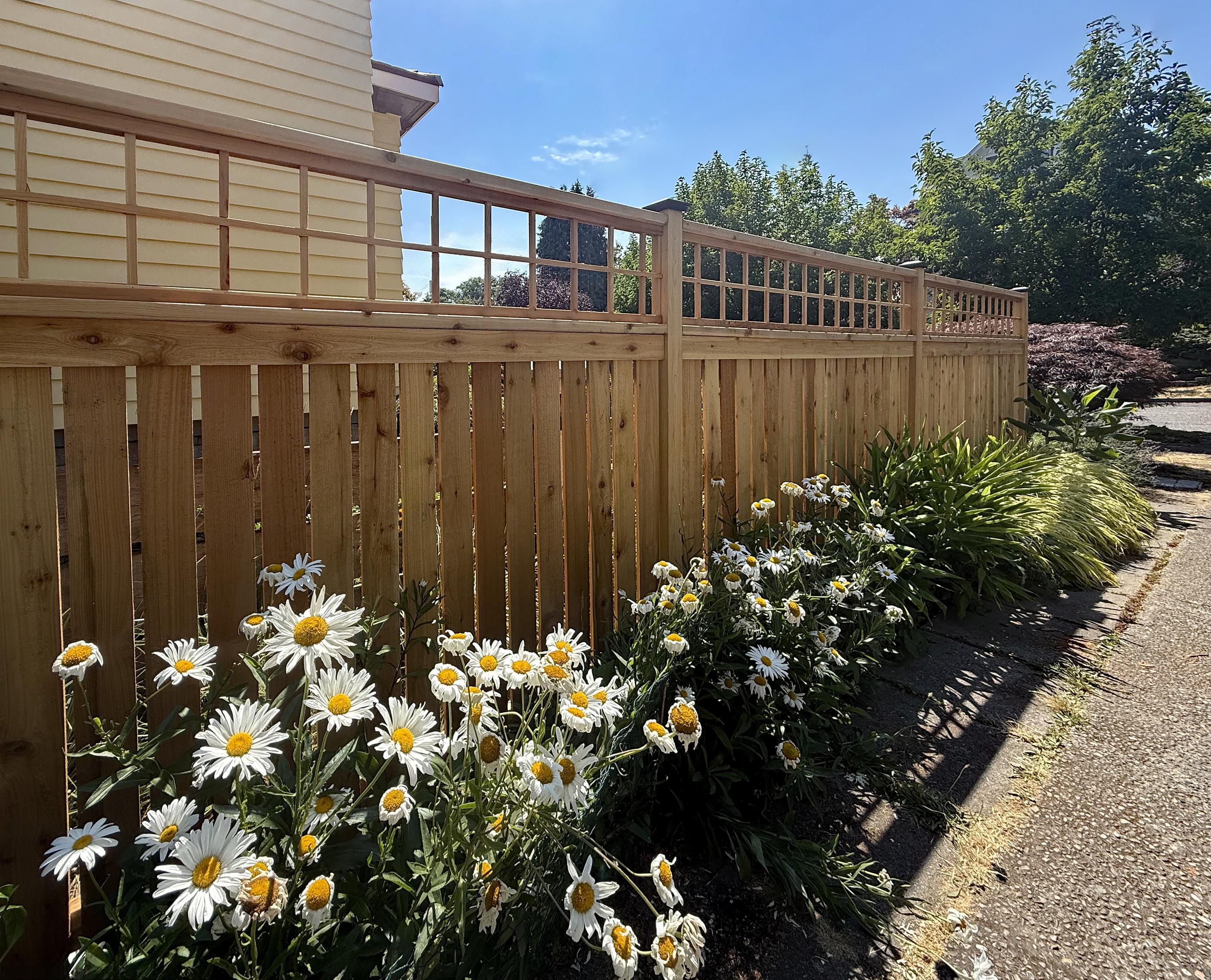 wood spaced picket fence installed by top rail fence