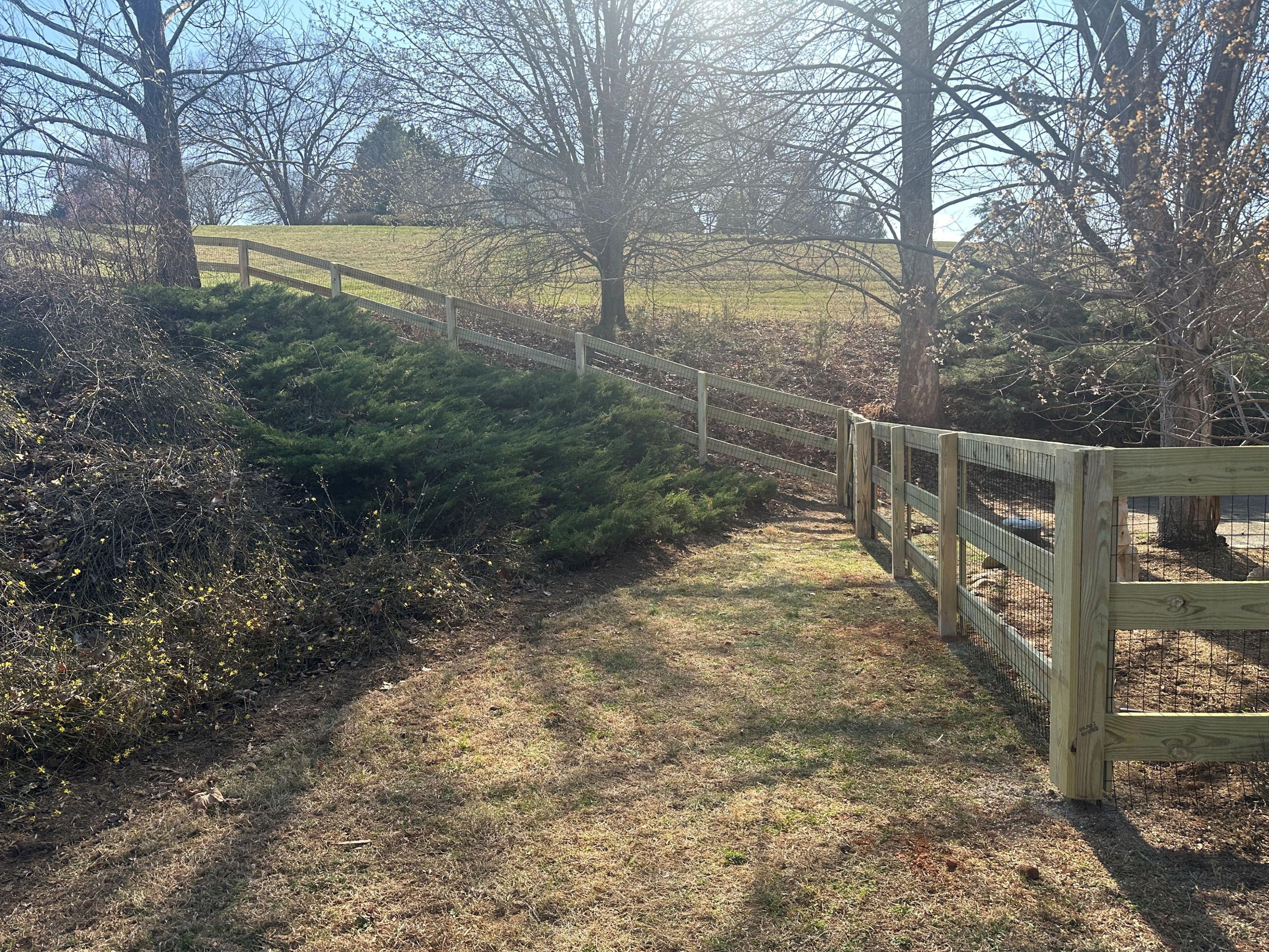 wood ranch rail fence installed by top rail fence