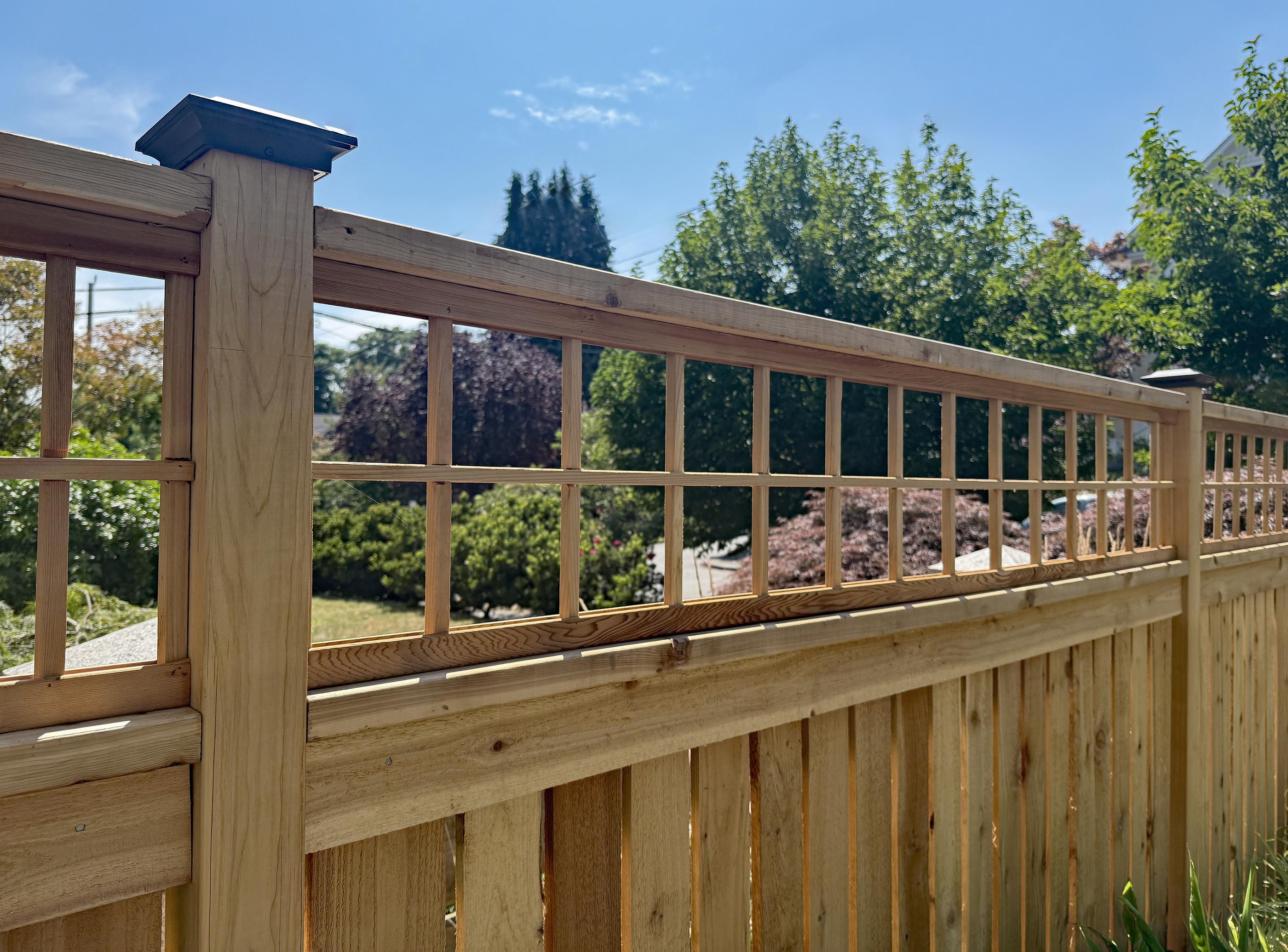 wood spaced picket fence installed by top rail fence