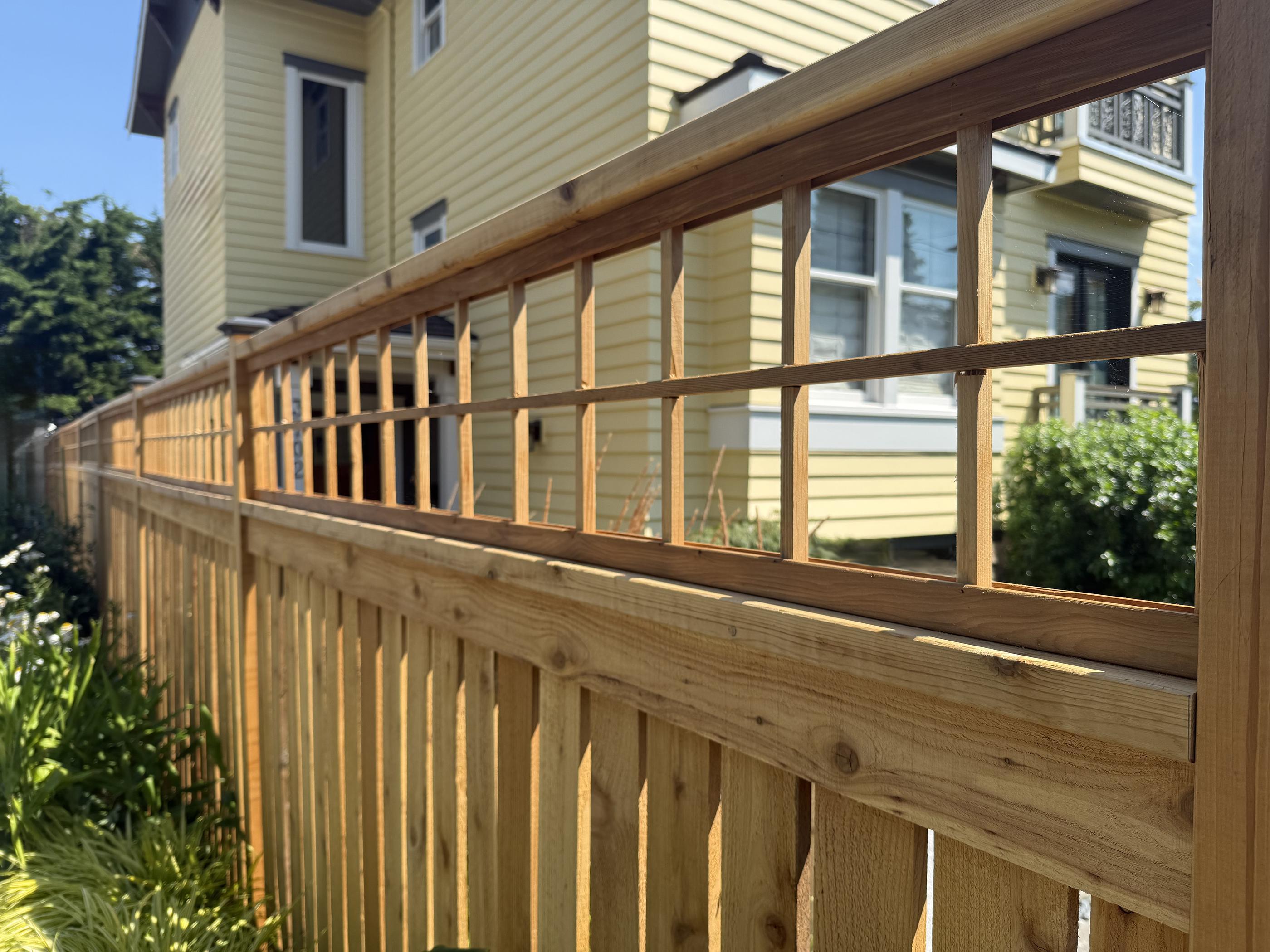 wood spaced picket fence installed by top rail fence