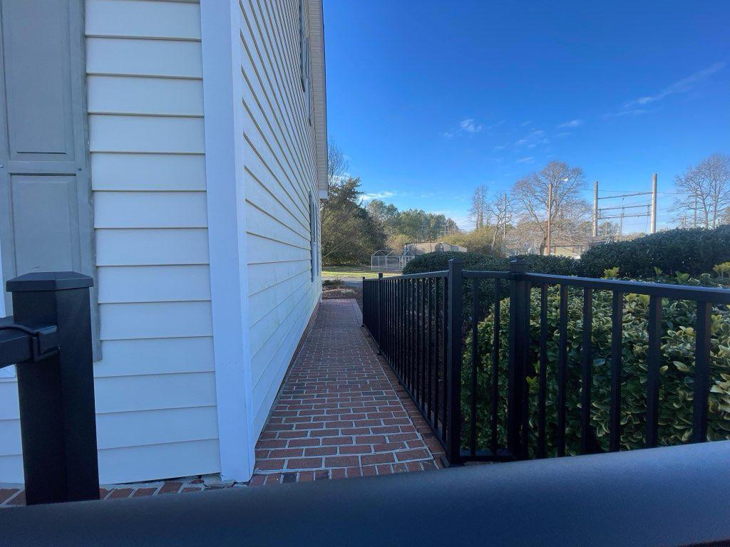 ornamental metal railing installed by top rail fence
