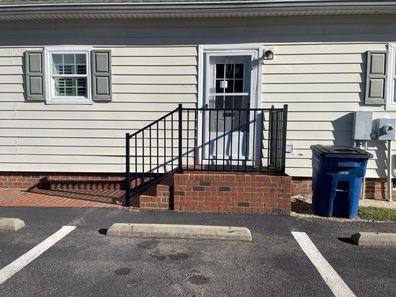 ornamental metal railing installed by top rail fence