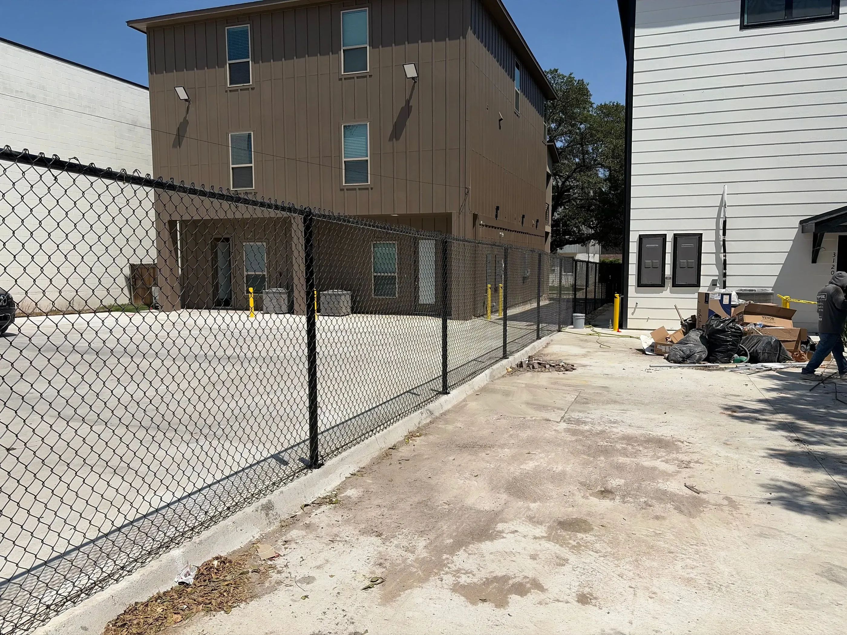 black chain link fence installed by top rail fence