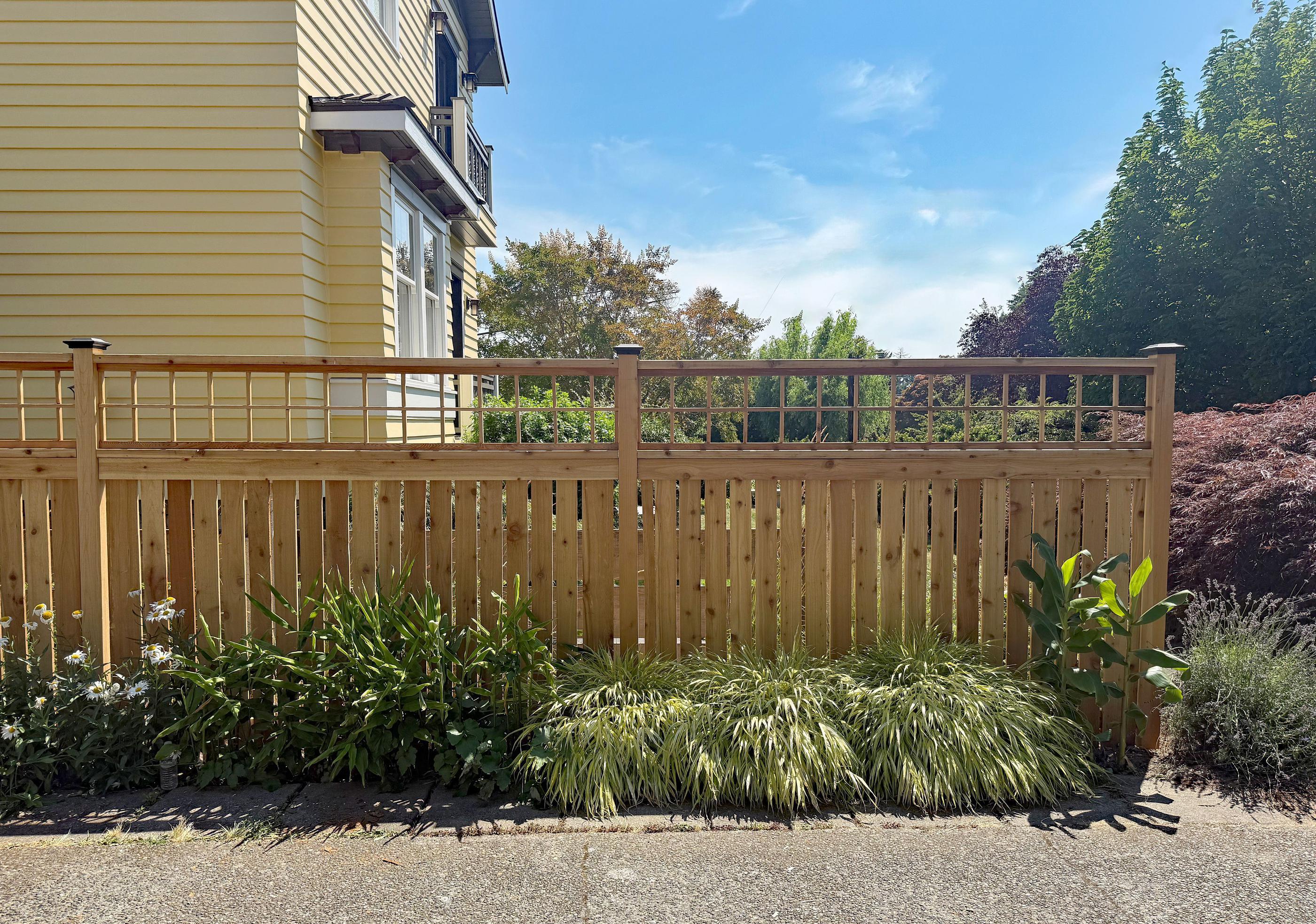 wood spaced picket fence installed by top rail fence