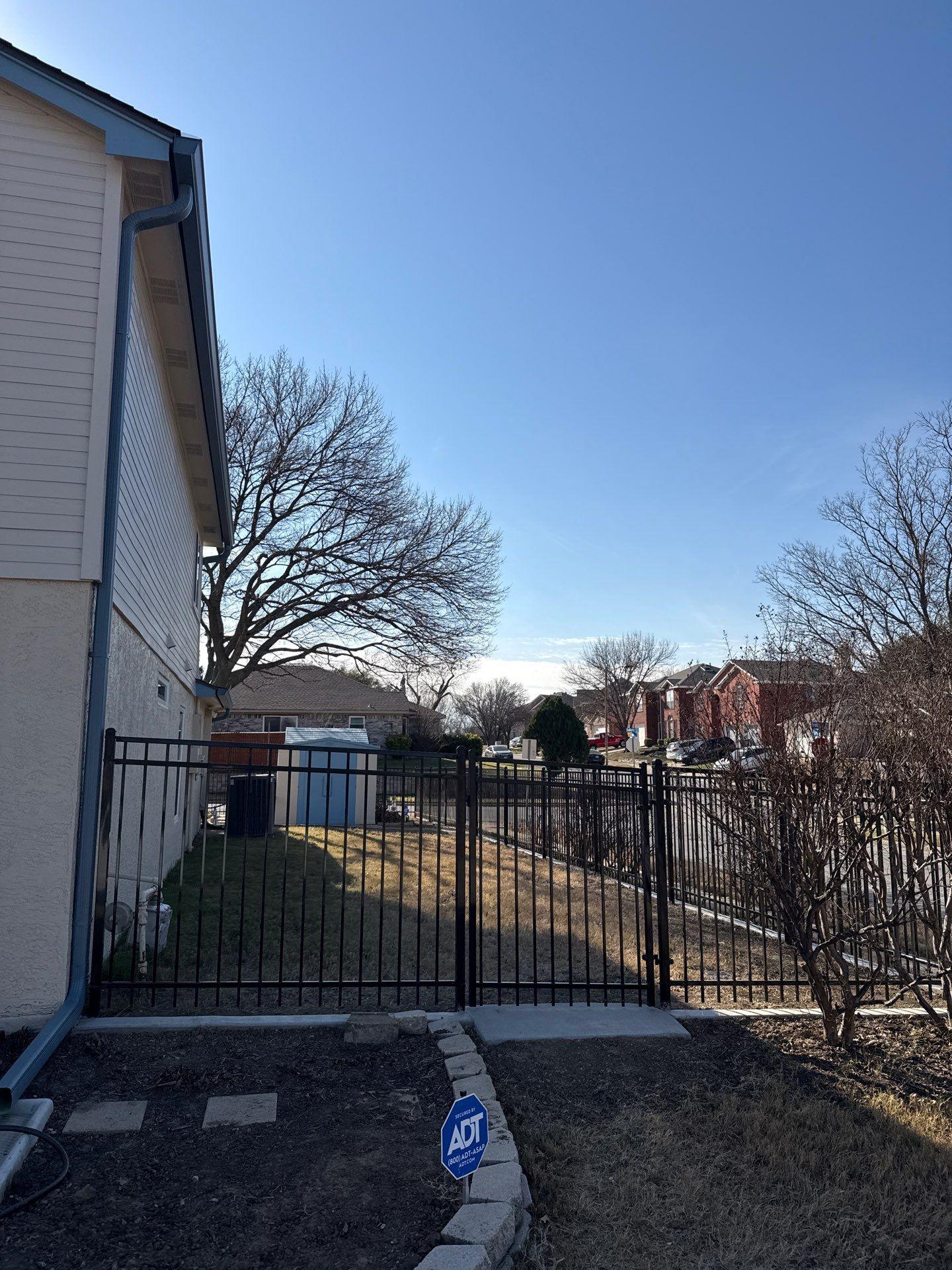 ornamental metal fence installed by top rail fence