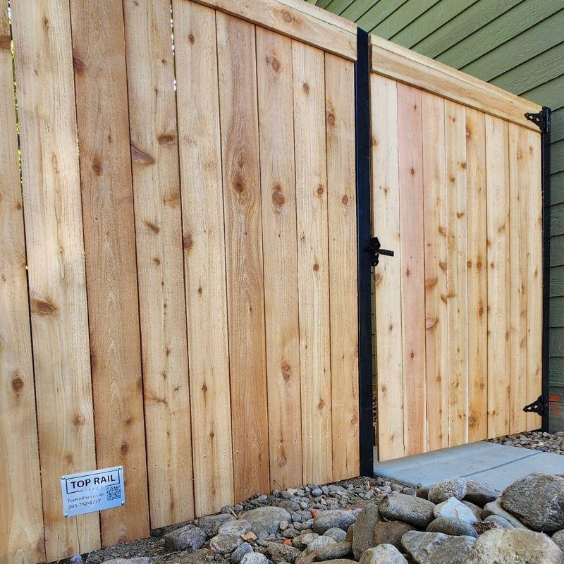 wood privacy fence with steel posts installed by Top Rail Fence