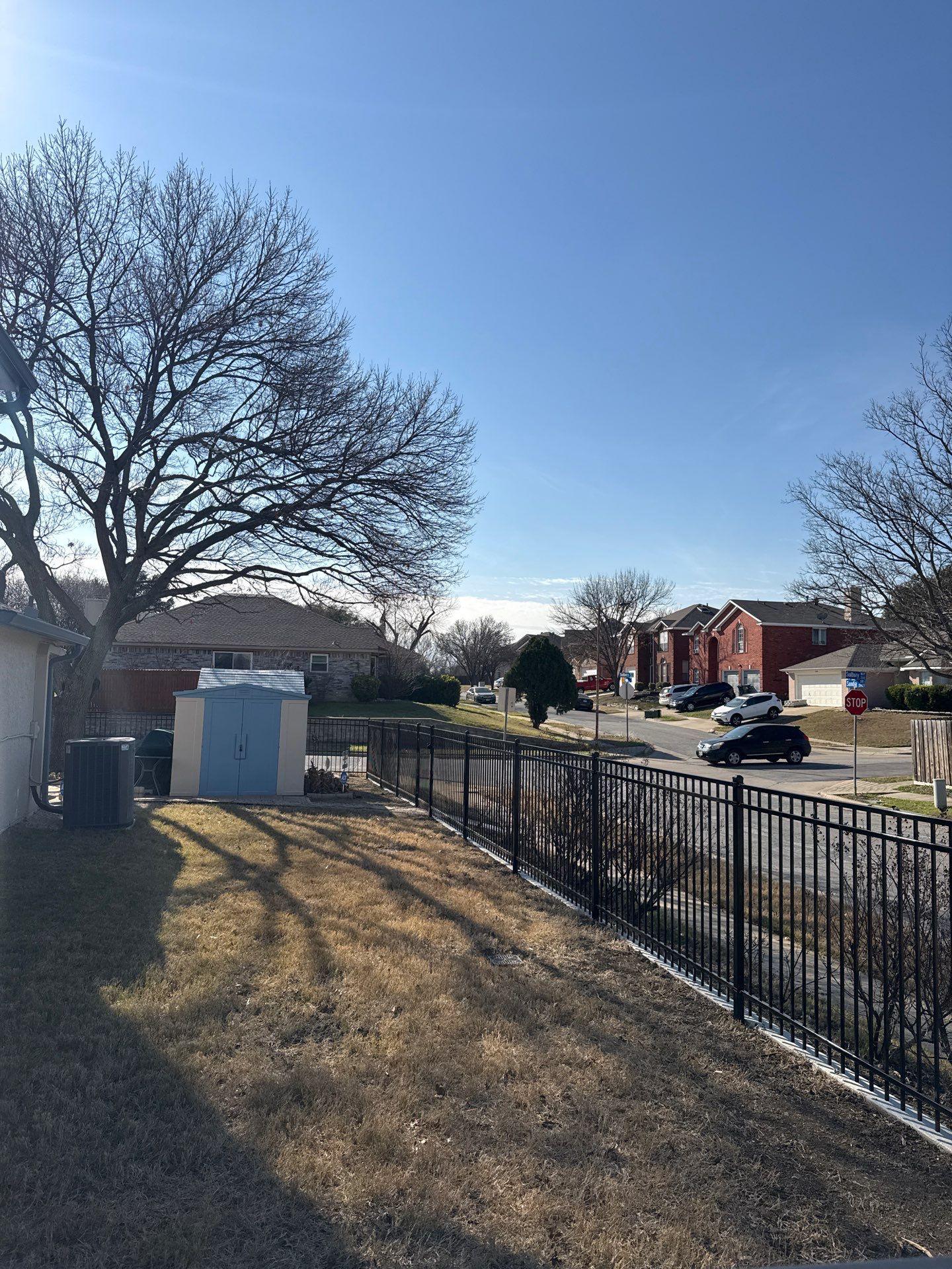 ornamental metal fence installed by top rail fence