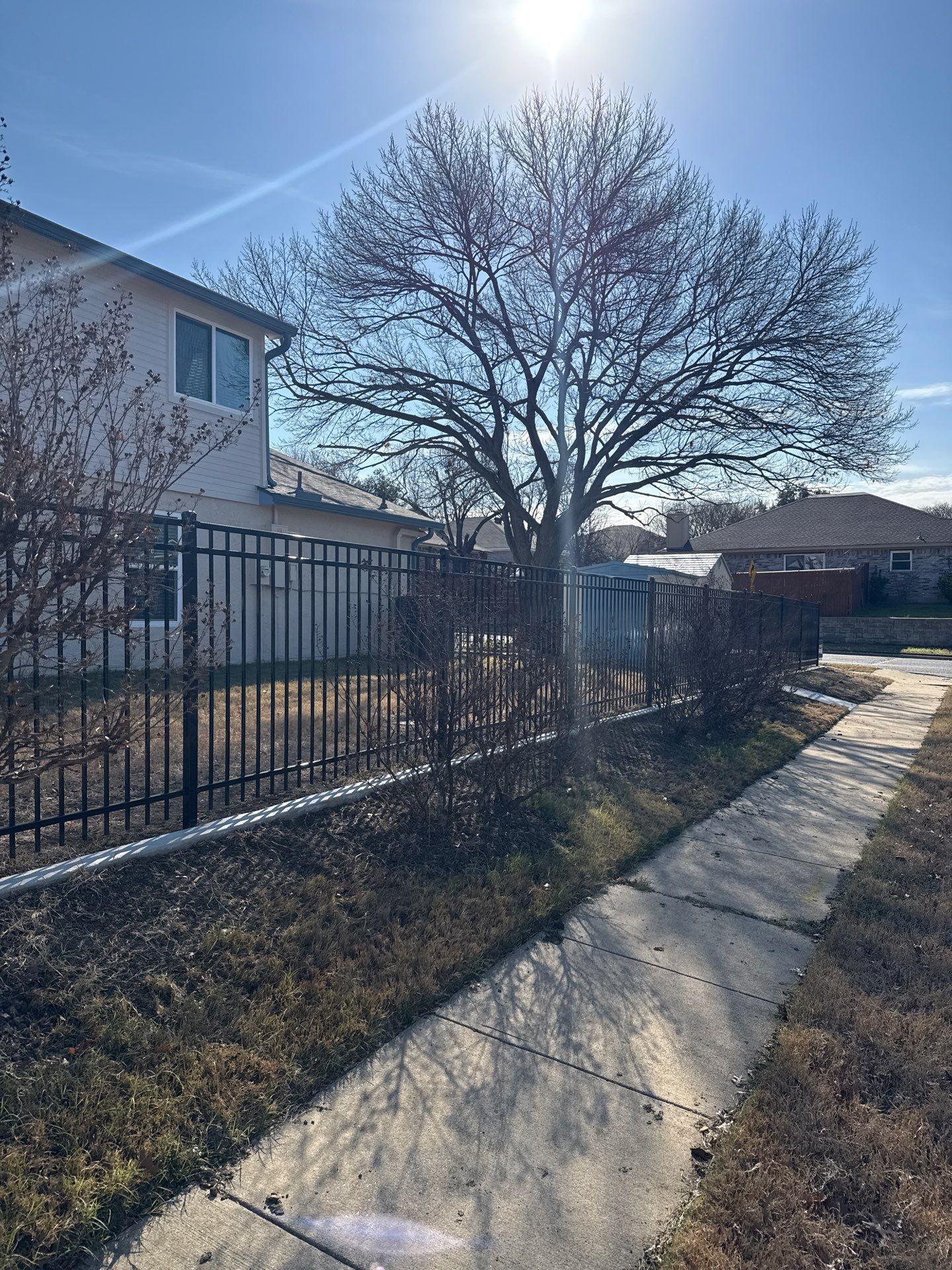 ornamental metal fence installed by top rail fence