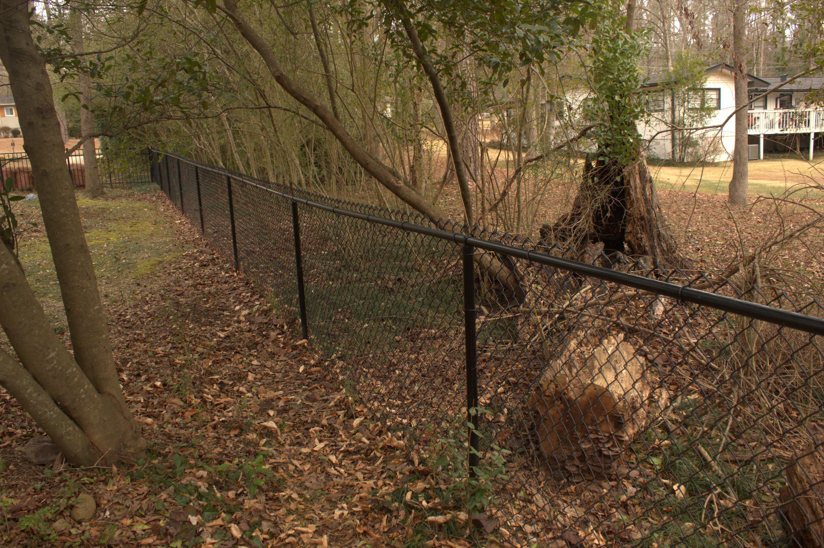 black chain link fence installed by top rail fence