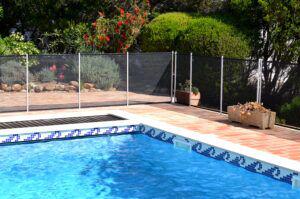 Swimming pool with safety mesh fence