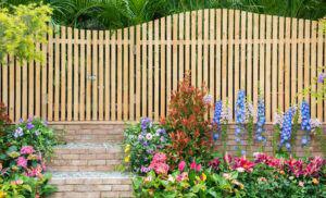 entrance and wooden fence of backyrad flower garden