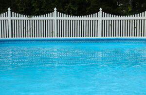 Vinyl picket fence around a pool