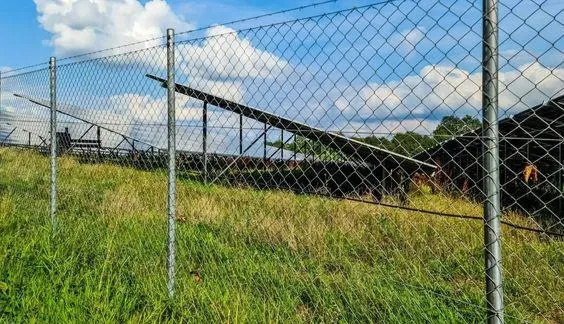 chain link fence around solar panel farm