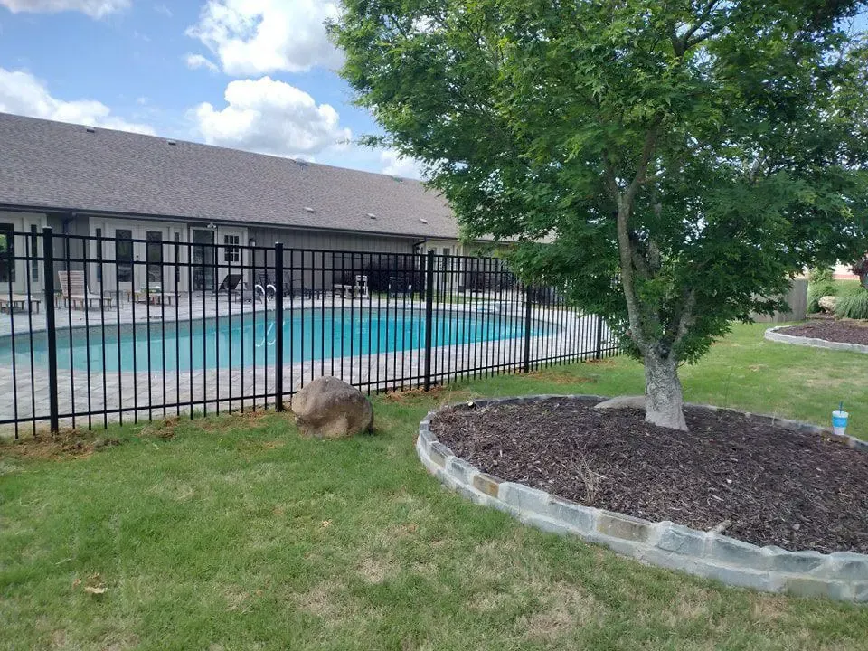ornamental metal fence installed by top rail fence