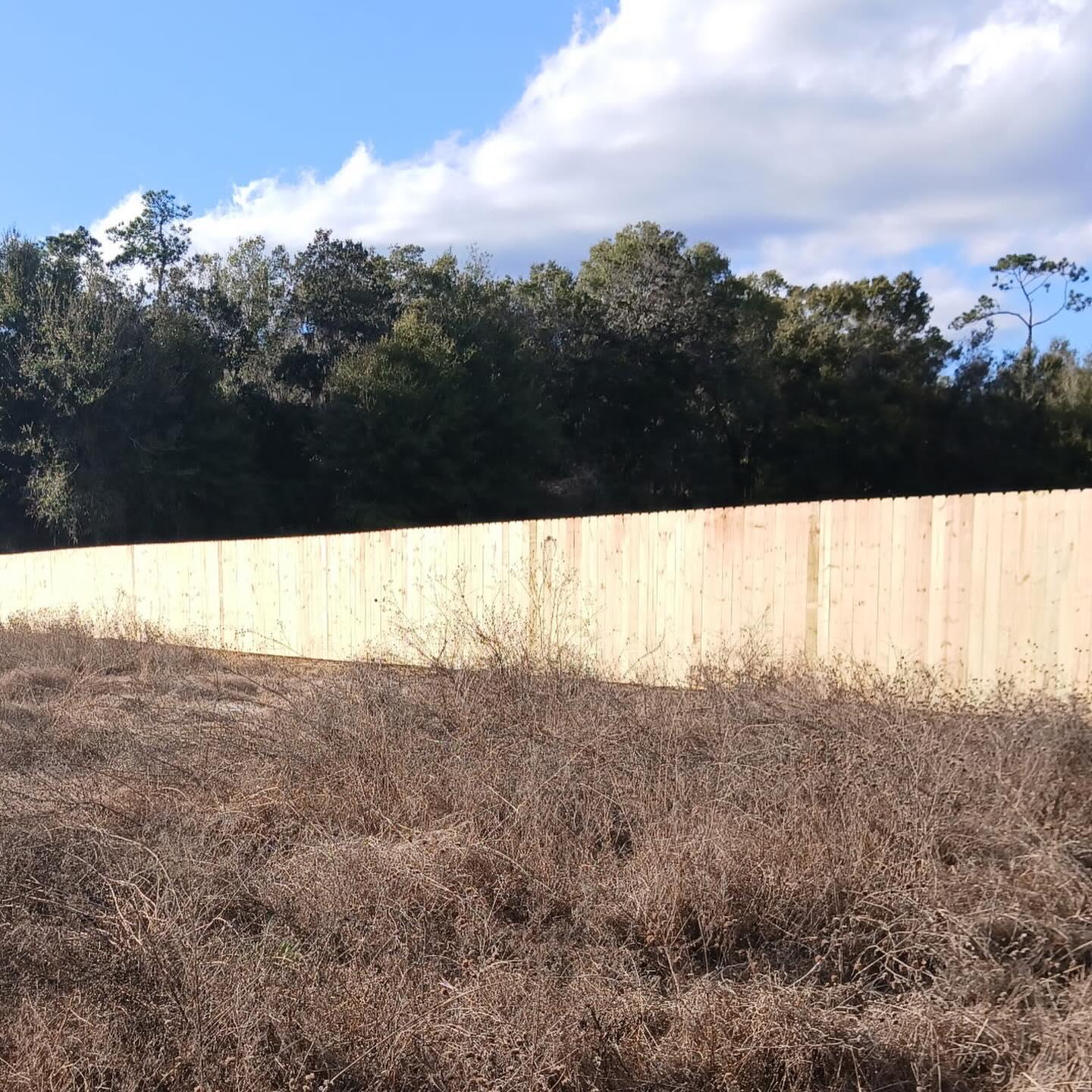 wood stockade fence installed by top rail fence