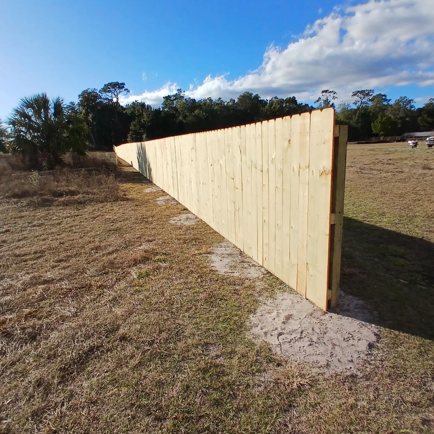 wood stockade fence installed by top rail fence