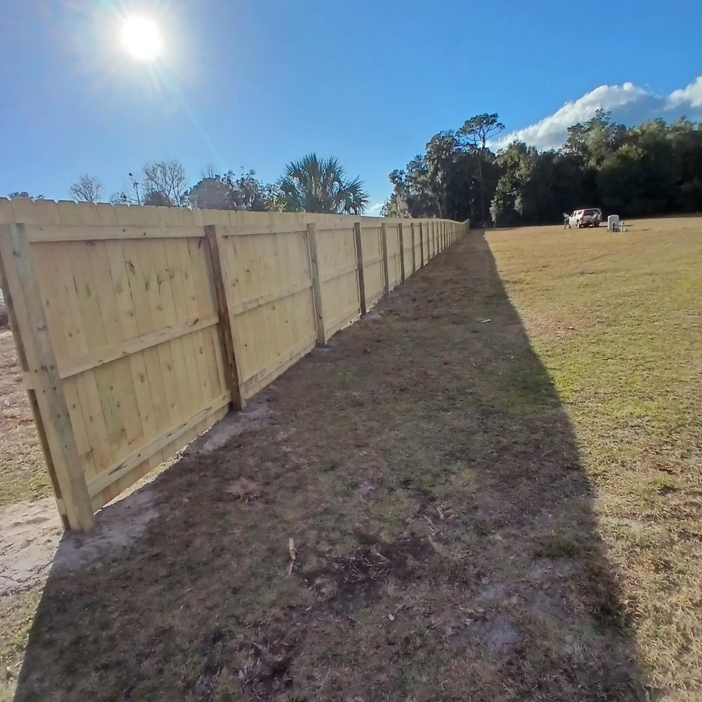 wood stockade fence installed by top rail fence