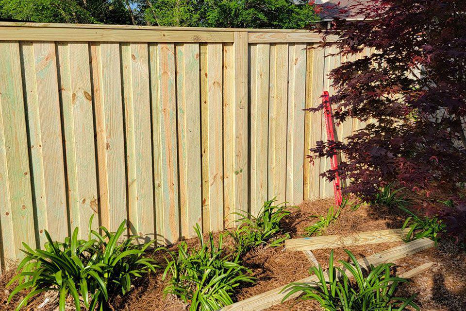 Board-on-board wood fence by Top Rail Fence