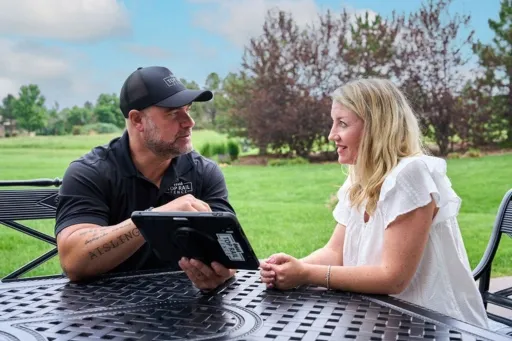employee reviewing fence options with a customer