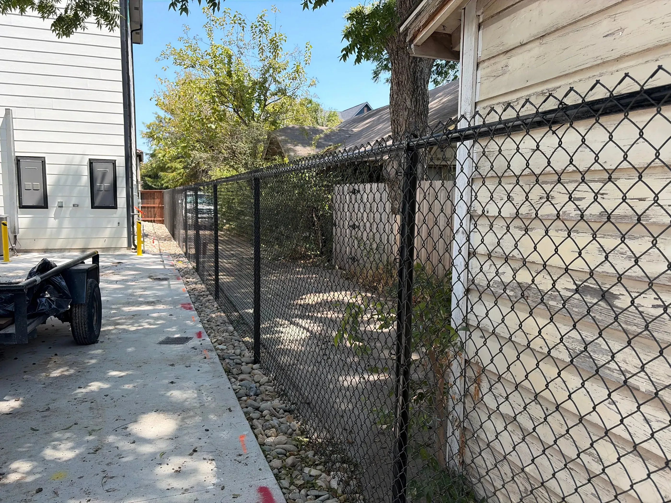 black chain link fence installed by top rail fence
