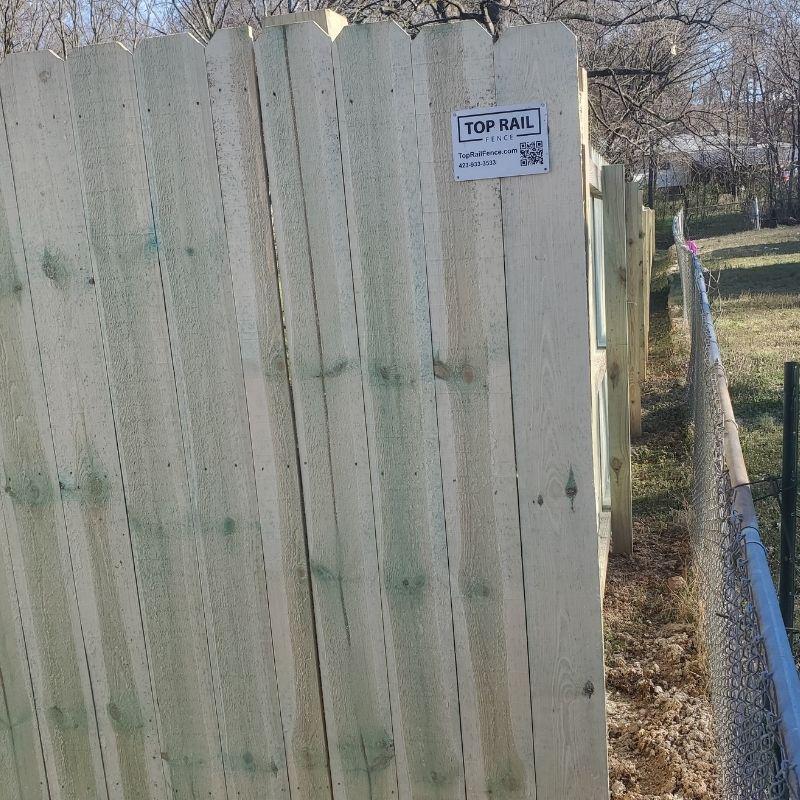 Pressure treated pine stockade fence installed by Top Rail Fence