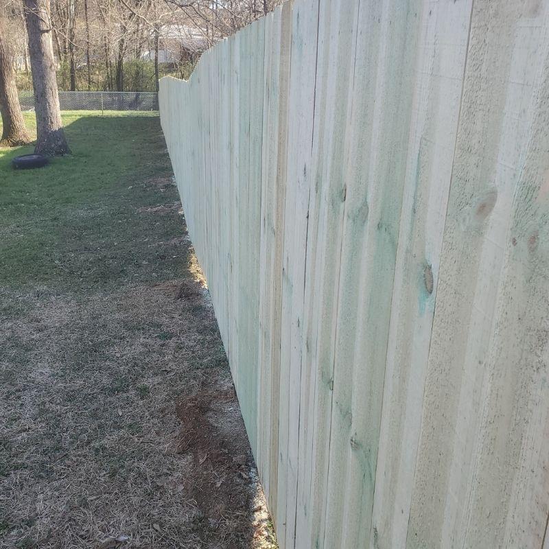 Pressure treated pine stockade fence installed by Top Rail Fence