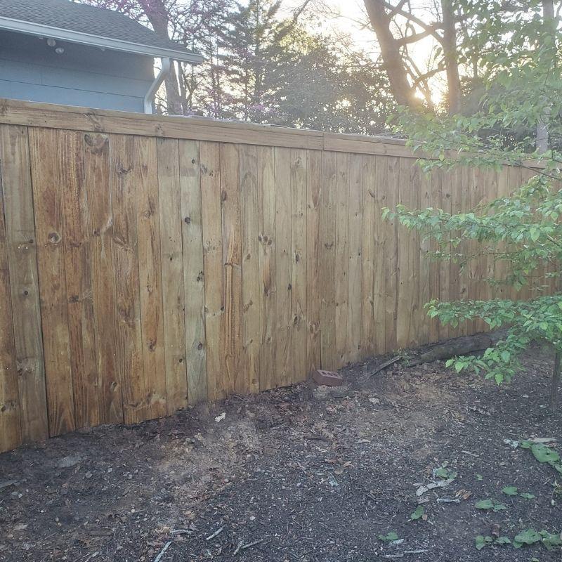pressure-treated pine privacy fence in a Charleston cap-and-trim style