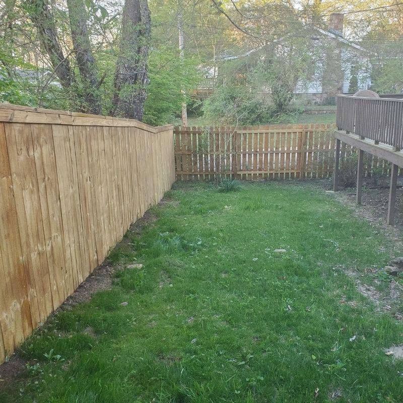 pressure-treated pine privacy fence in a Charleston cap-and-trim style