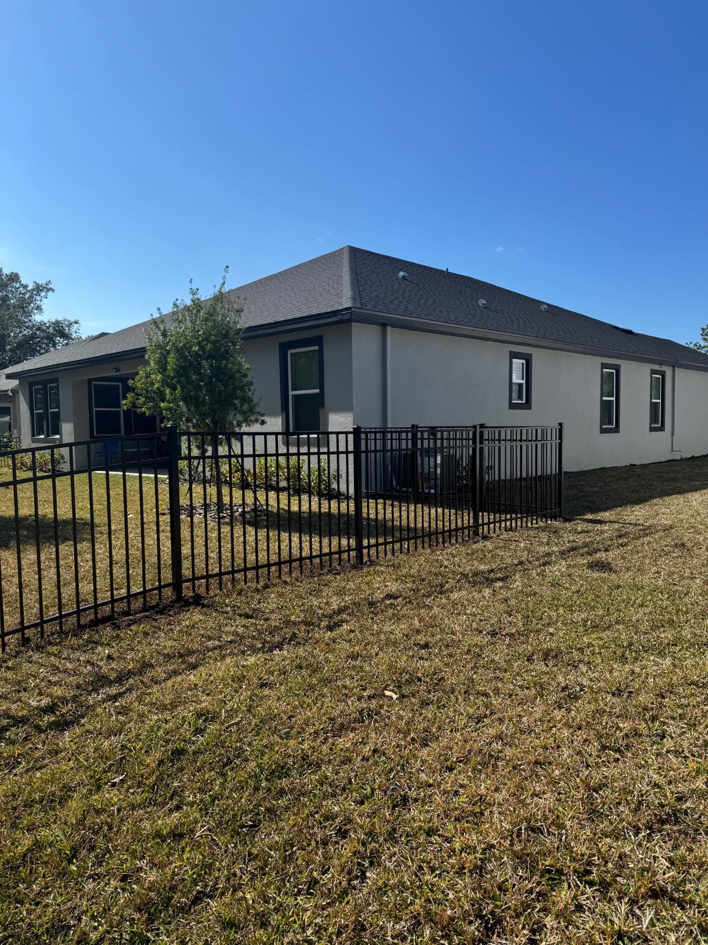 ornamental metal fence installed by top rail fence
