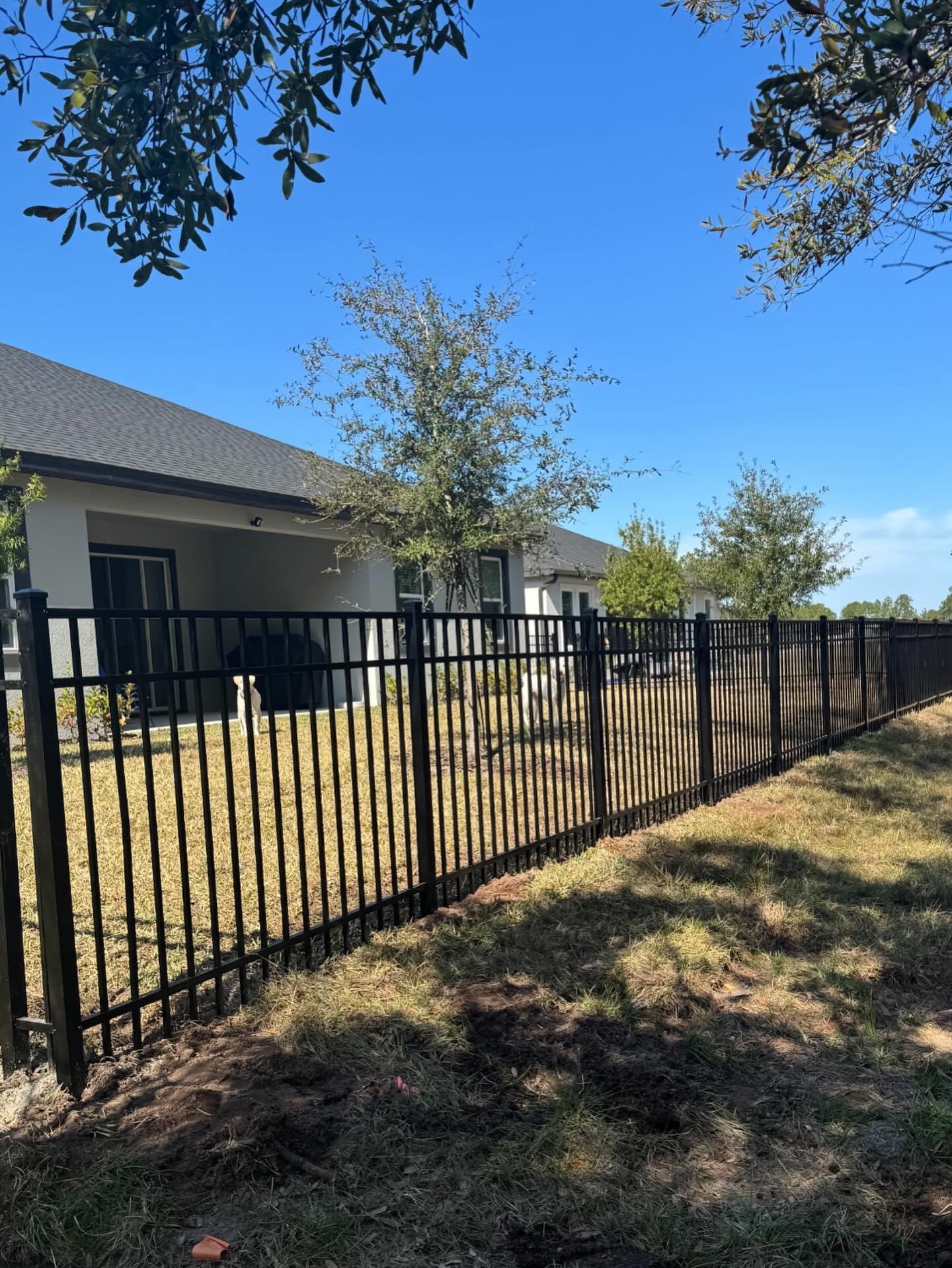 ornamental metal fence installed by top rail fence
