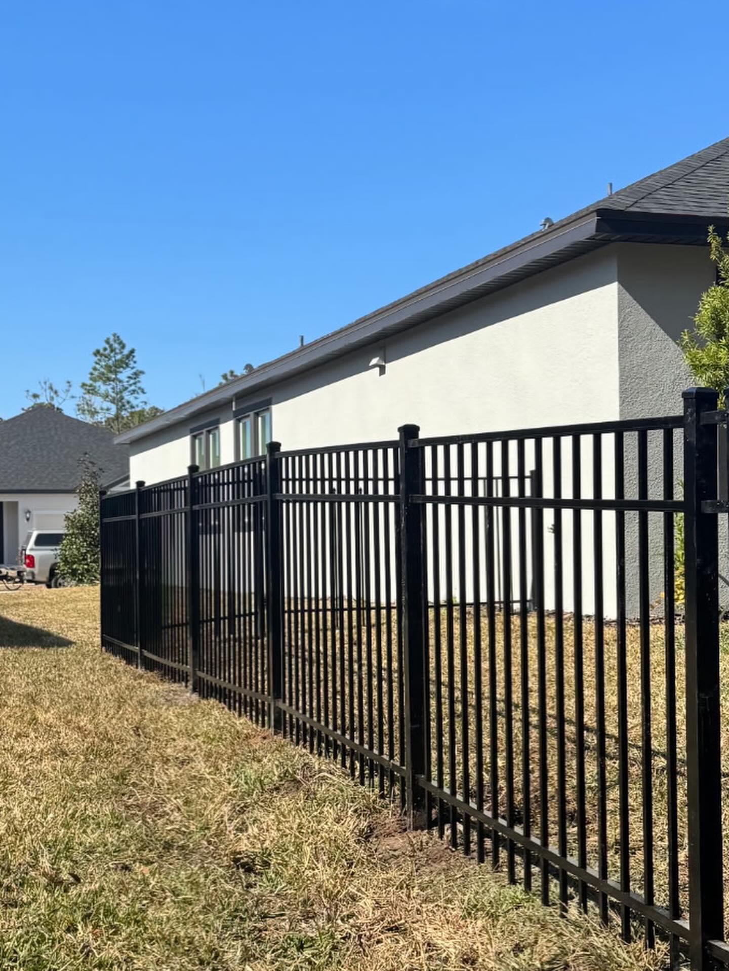 ornamental metal fence installed by top rail fence