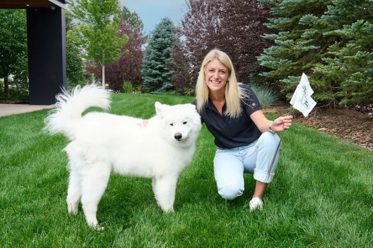 smiling employee with customers dog