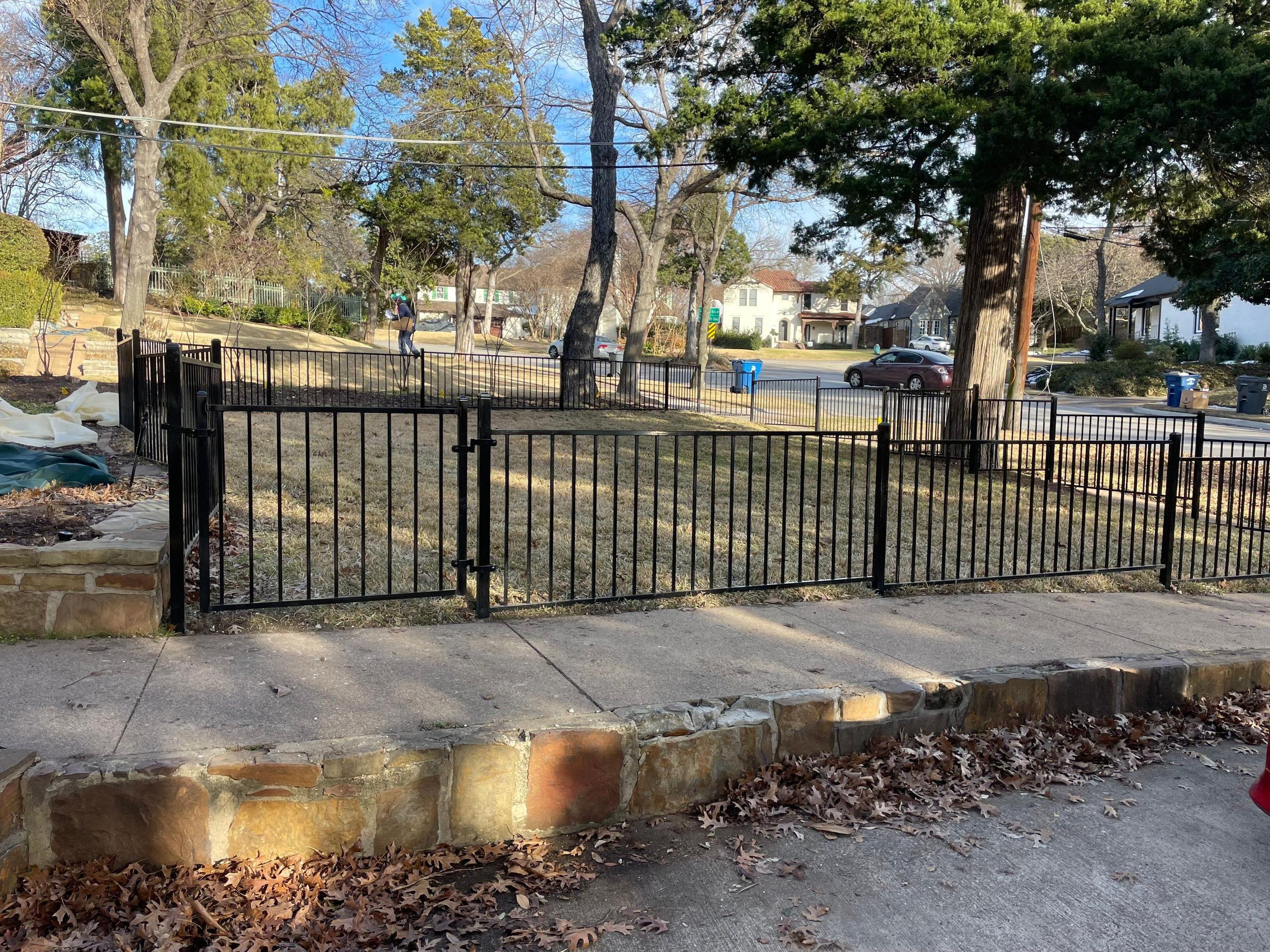 ornamental metal fence installed by top rail fence