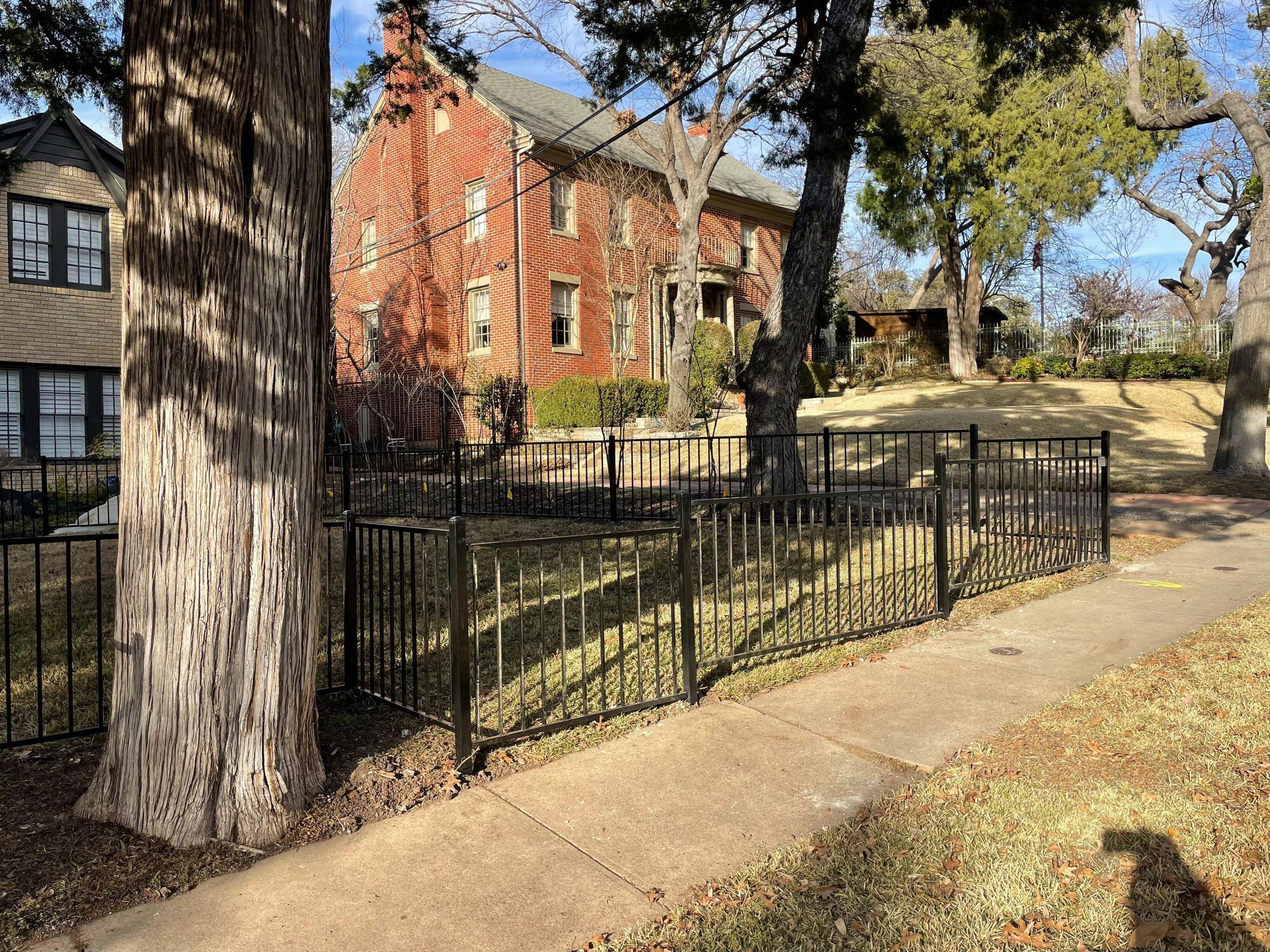 ornamental metal fence installed by top rail fence