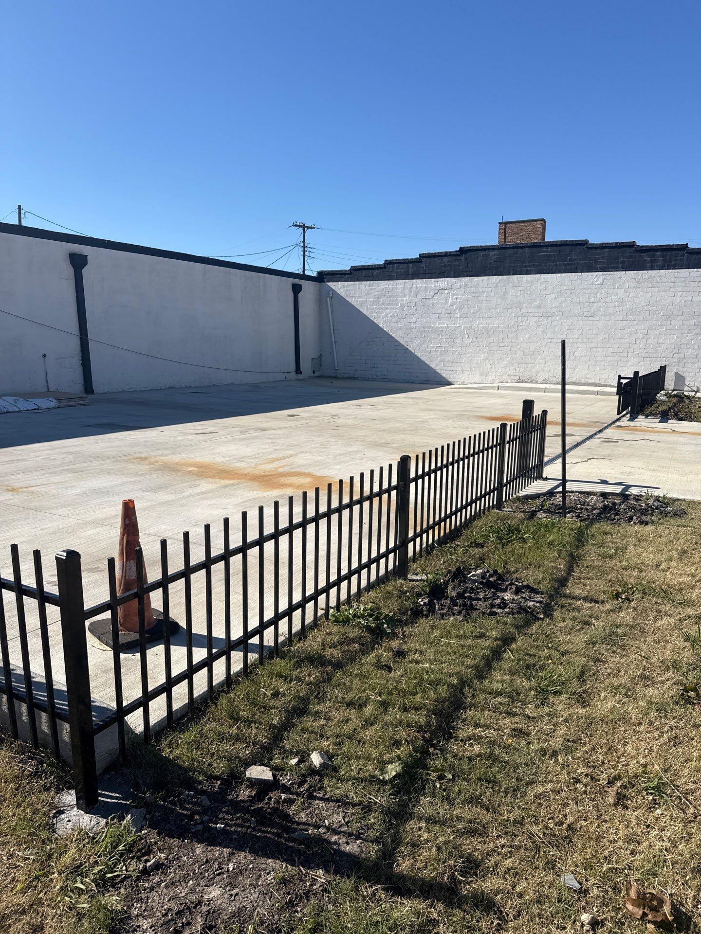 ornamental metal fence installed by top rail fence