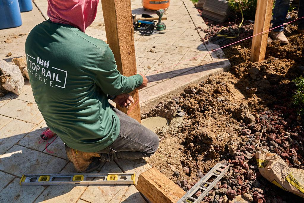 Employee installing a fence.