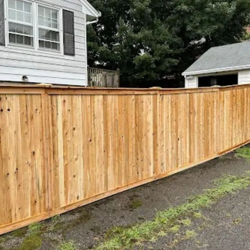 Cap and trim wood fence by Top Rail Fence