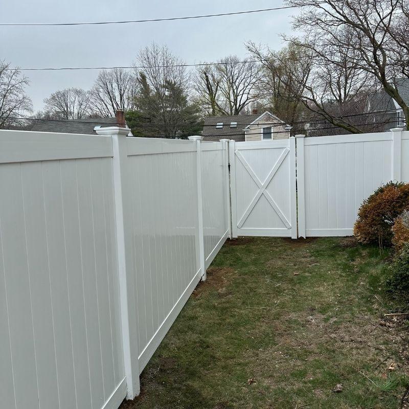 new white vinyl fence installed by Top Rail Fence