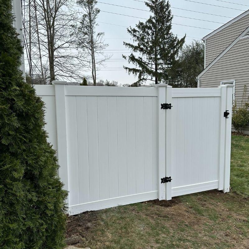 new white vinyl fence and gate installed by Top Rail Fence