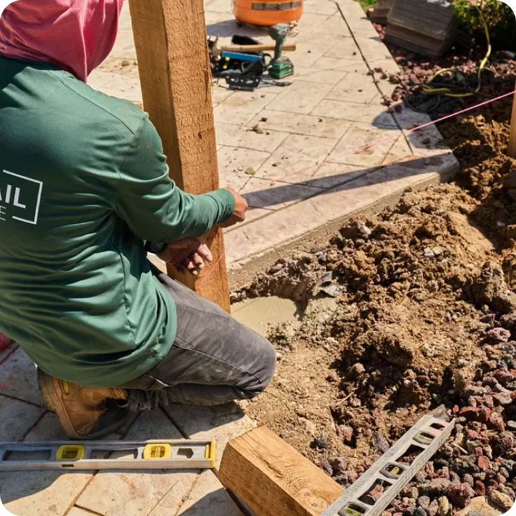 worker installing a wood pole