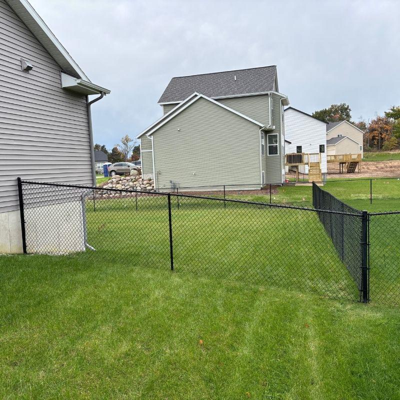 black chain link fence installed by top rail fence holland