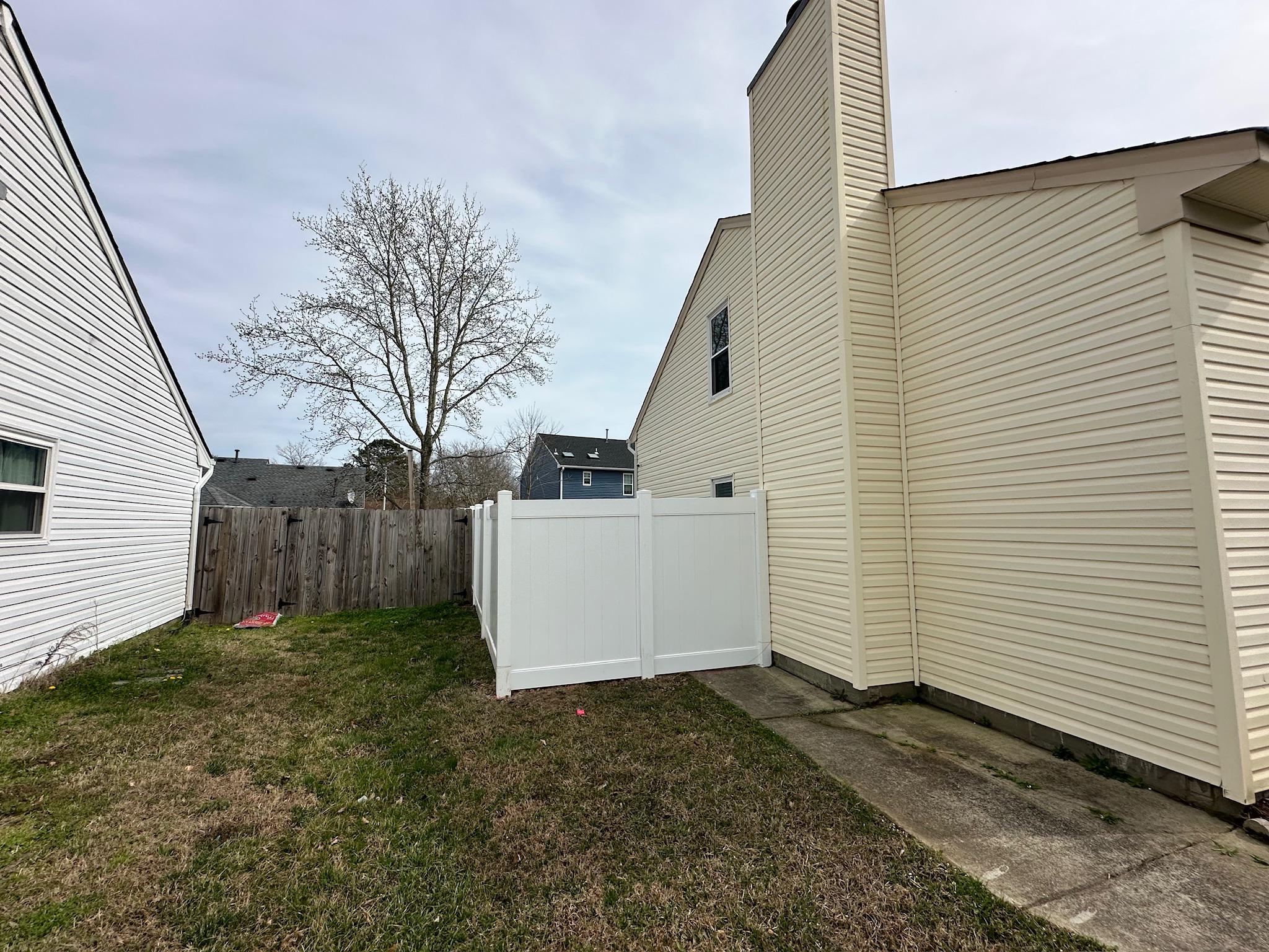 white vinyl fence installed by top rail fence