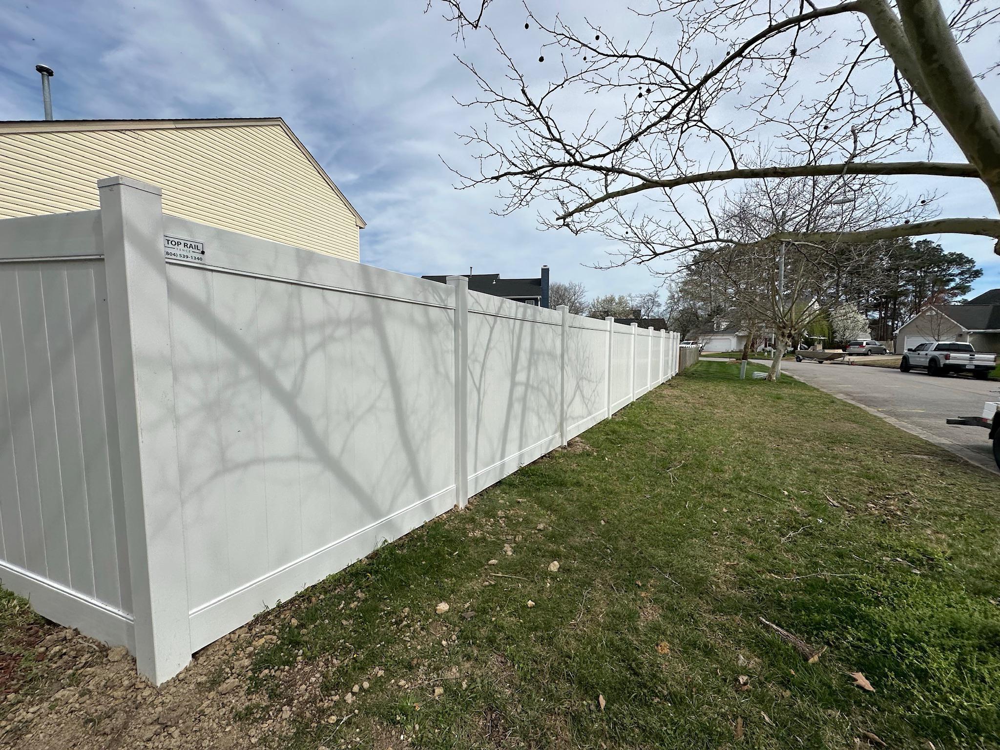 white vinyl fence installed by top rail fence